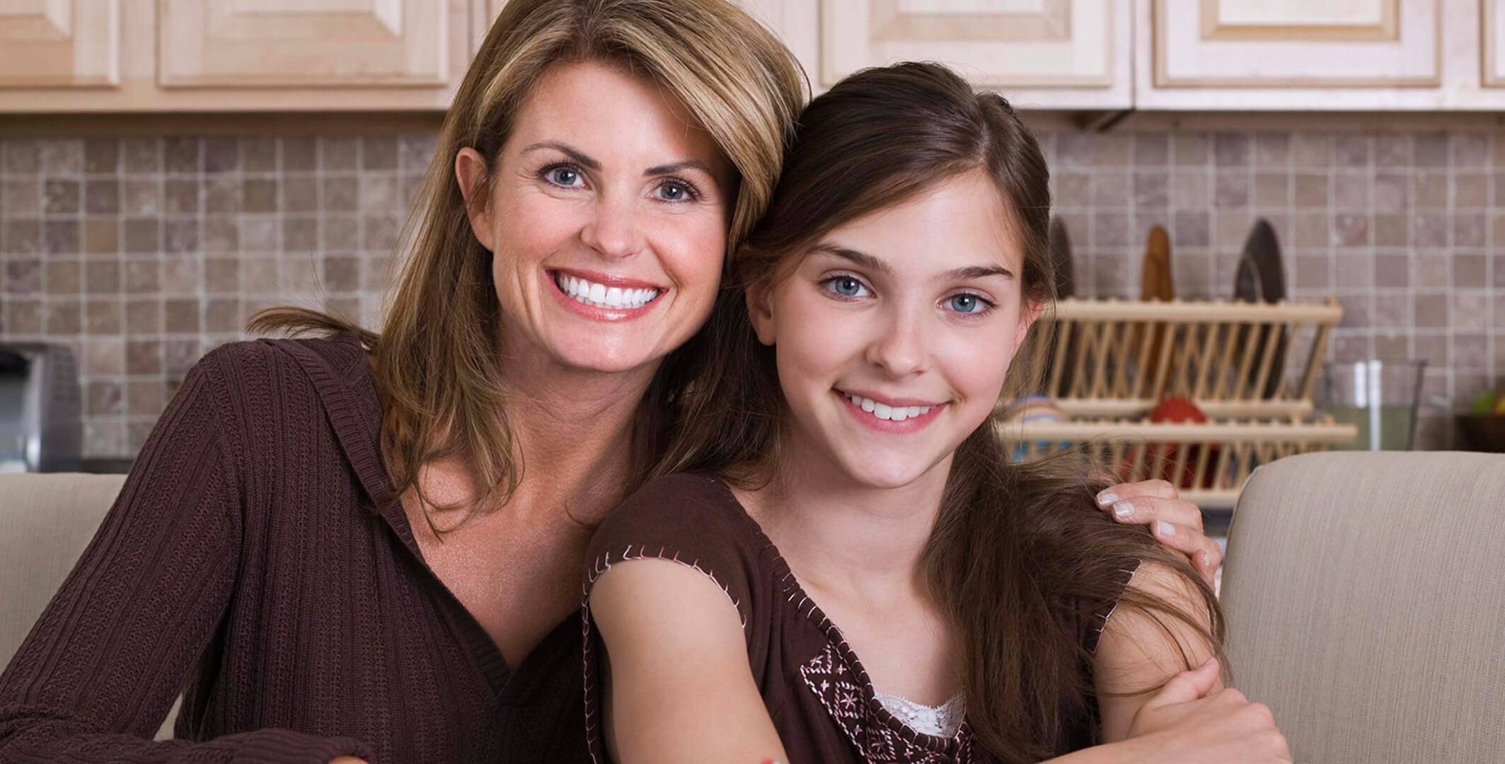 A woman and her daughter smiling